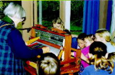 Children watching tartan weaving